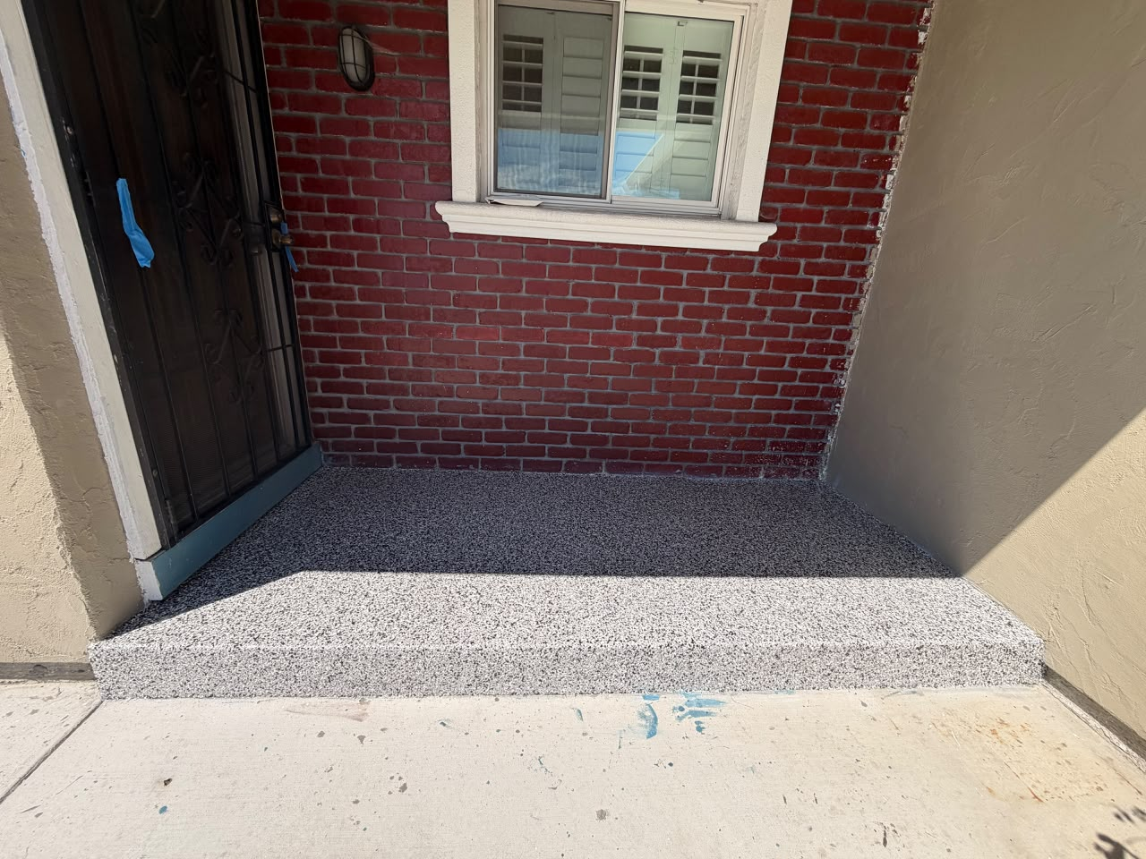 Entryway and step after installation of a flake epoxy finish